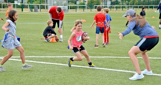 Child running during a flag football activity